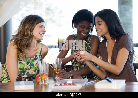 Friends sharing earphones listening to music together Stock Photo