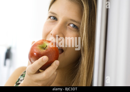 Young woman biting into apple Stock Photo