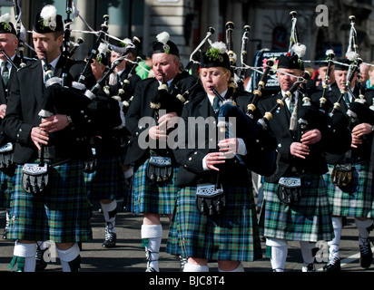 Pipers of the St Nauls Pipe Band marching during the St Patricks Day celebrations in London. Stock Photo