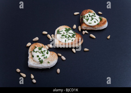 Three Heart-shaped portions of food, on black background Stock Photo