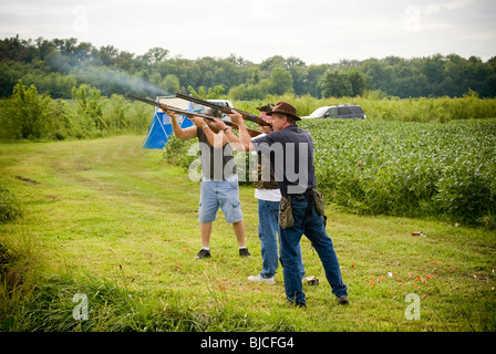 Three dove hunters shooting guns Stock Photo