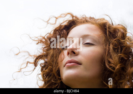 Young woman with eyes closed and serene expression on face, portrait Stock Photo