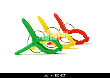 Colorful plastic clothes pegs standing diagonally isolated on white background Stock Photo