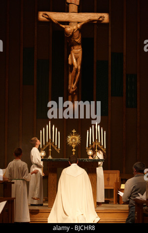 Priest celebrating the veneration of the Eucharist Stock Photo