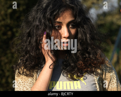 Indian woman talking on a mobile phone and smiling Stock Photo - Alamy