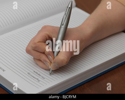 Hand Holding Pen Wrinting Notes Close up Stock Photo