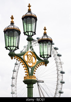 Street lights on Westminster Bridge in front of London Eye Stock Photo