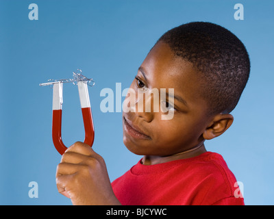 Child holding a magnet. Stock Photo