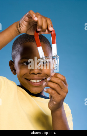 Child holding a magnet. Stock Photo