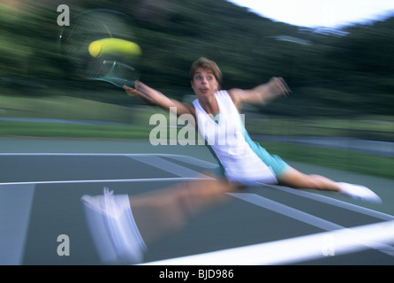 Female tennis player in action Stock Photo