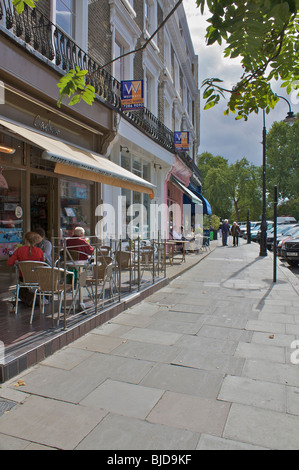 Primrose hill high street showing cafe on a sunny day with a few people out on the pavement. Portrait Stock Photo