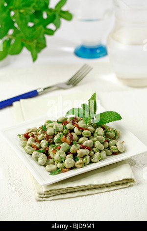 Fresh broad beans with ham and mint. Recipe available. Stock Photo