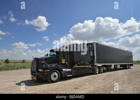 A black truck on a sandy parking lot on the steppe in New Mexico, USA Stock Photo