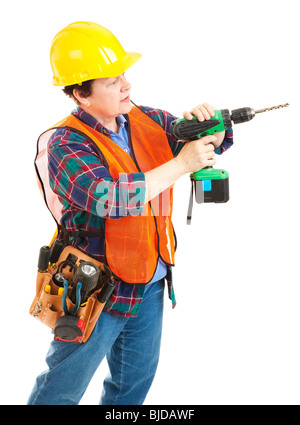 Female construction worker using a power drill. Isolated on white. Stock Photo