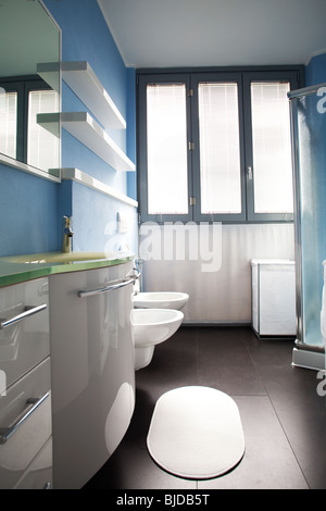 Modern white cabinets shiny polished in bathroom belonging to a studio apartment Stock Photo