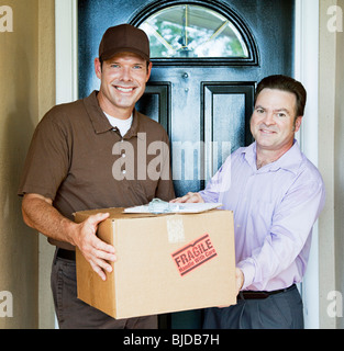Pulling Handless Delivery man in a blue polo shirt holding a package carton bag with ...