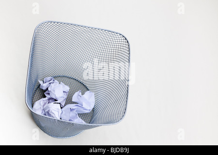 Studio still life UK. Metal mesh waste paper bin on a white background from above Stock Photo
