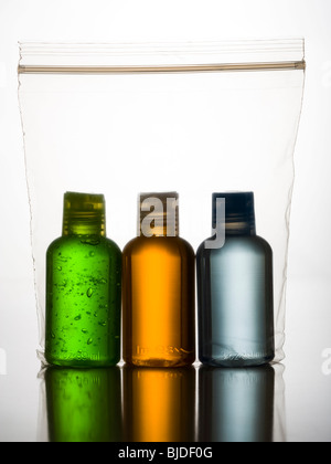 three different Colored bottles in a plastic bag. Stock Photo