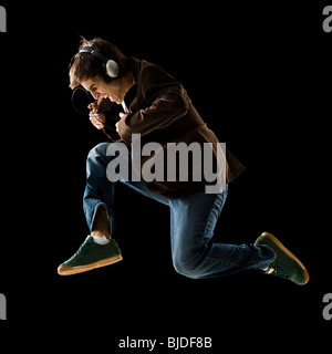 Young man listening to earphones and dancing. Stock Photo