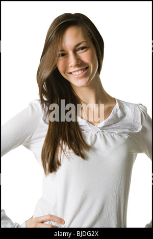 A young woman in a white shirt and jeans with hands outstretched ...
