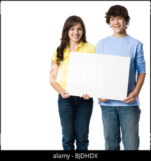 young couple holding a sign Stock Photo