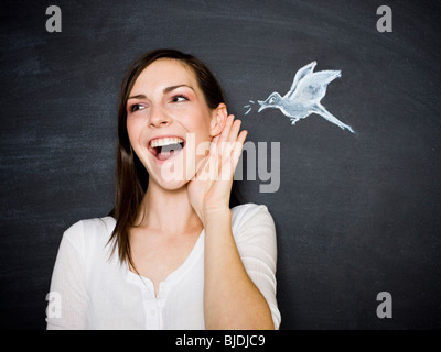 young woman against a chalkboard Stock Photo