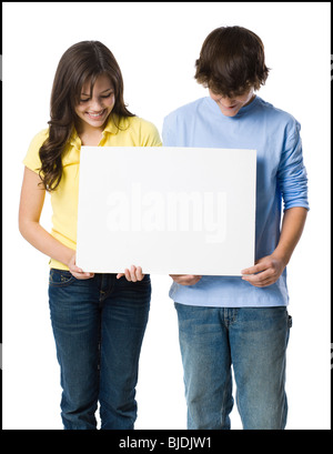 young couple holding a sign Stock Photo