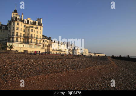 Looking East along Eastbourne Beach and seafront at sunrise with the Queens Hotel in the foreground. Stock Photo