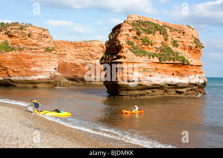 People landing Kayaks at Ladram Bay, Devon England UK Stock Photo