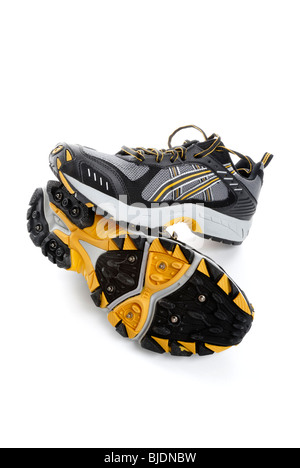 Water-proof running shoes with spikes for traction on snow and ice Stock Photo
