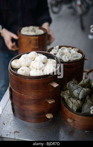 Chinese steamed dumplings (baozi and jiaozi) at a streetside restaurant in Changdu, Sechuan, China. Stock Photo