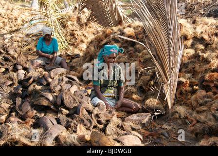 Native Kerala Women Working in the extraction of coir from coconut Husk in Small scale Coir Industry at Kerala India Stock Photo