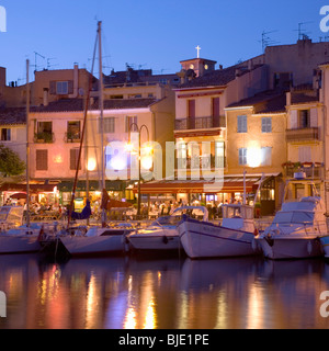 Cassis, Provence, France. View across the illuminated harbour at dusk. Stock Photo