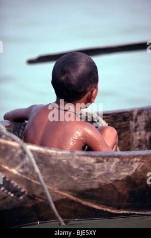 A Moken boy, sea gypsies of the Andaman sea on his boat house, kabang ...