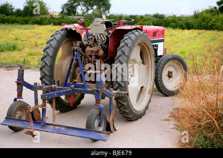 Agriculture aged red tractor retro vintage machine Stock Photo