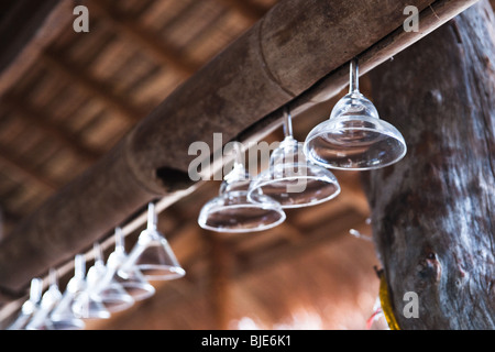 Travel detail image of hanging glasses in a tropical bamboo bar on Koh Lanta, an island outside Phuket, in Thailand. Stock Photo