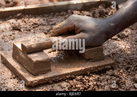 Laying concrete to make floor of a new cow shed, Rwanda. Stock Photo