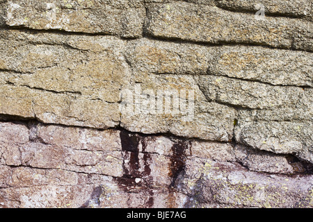 Stone surface with cracks, smudges and lichen Stock Photo