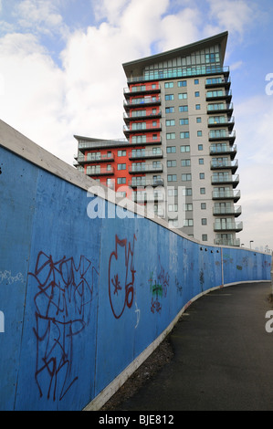 Modern apartment block at Woolwich with graffiti on hoarding Stock Photo