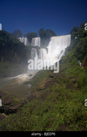 tourists at viewpoint underneath the adan y eva adam and eve fall on the lower circuit in iguazu national park argentina Stock Photo