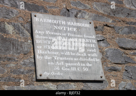 Inscribed slate sign on the wall of the Harbour Master's office in Barmouth Harbour prohibiting dumping into the harbour Stock Photo