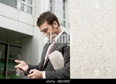 Businessman using mobile phone, waist up Stock Photo