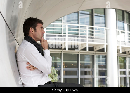 Thoughtful businessman standing in archway, side view Stock Photo