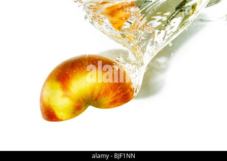 Half of apple splashing to fresh water Stock Photo