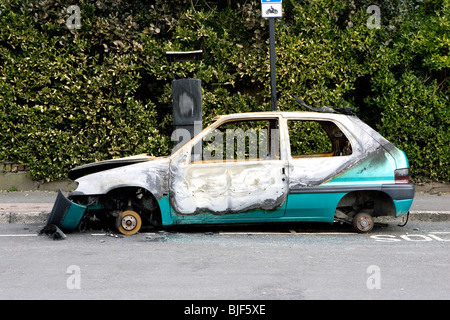 A burnt car that has been dumped on the streets of Brighton. Stock Photo