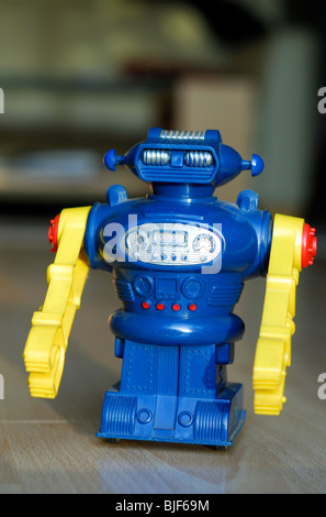 An early 1970s made-in-Hong-Kong battery-operated toy robot on a modern living room floor. Stock Photo