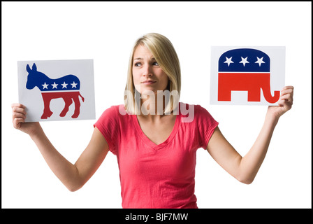 woman holding up political party signs Stock Photo