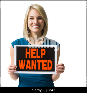 woman holding a help wanted sign Stock Photo