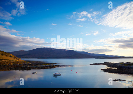 small boats at anchour in calm water on Kenmare River, Co.Kerry, Ireland with mountains in background Stock Photo