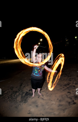 FIRE TWIRLING ON MOOLOOLABA BEACH Stock Photo